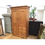 A modern John Lewis pine upright gentleman's linen style press with twin panel doors to top above