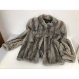 A grey mink coat (approximately shoulders: 46cm x length 67cm)