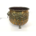 A 19thc brass jardiniere with leaf and hanging fruit border above a lobed base, with lion mask