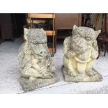 A pair of composition grotesque garden ornaments, one lacking corner to base (larger: 50cm x 35cm