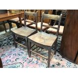 A pair of Scottish elm country dining chairs c.1800, with arched spar backs and shaped saddle