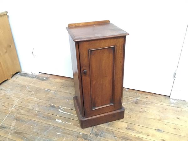 A Victorian mahogany bedside pot cupboard with moulded edge and inset panel door, on plinth base (