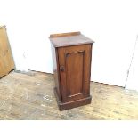 A Victorian mahogany bedside pot cupboard with moulded edge and inset panel door, on plinth base (