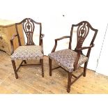 A pair of Sheraton style urn and pierced splat back open arm side chairs with stuffover seats, on