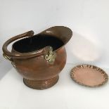 A large copper swing handled coal scuttle with brass mounts (33cm x 43cm x 36cm) and a copper salver