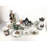 A mixed lot including a Staffordshire flatback figure of a Bagpiper, Royal Commemorative cups and