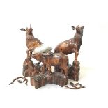 A pair of treen carved Stag standing figures, both with losses to antlers and ears, but present, and