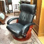 A bentwood and chrome mounted recliner easy chair upholstered in black leather, on circular swivel