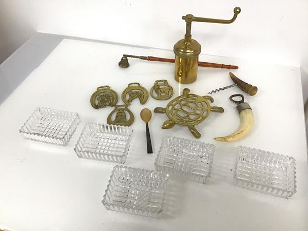 A collection of brassware including a trivet in the form of a turtle, horse brasses and a grinder