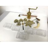 A collection of brassware including a trivet in the form of a turtle, horse brasses and a grinder