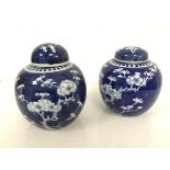 A near matching pair of Chinese ginger jars, both with cherry blossom decoration (taller: 16cm x