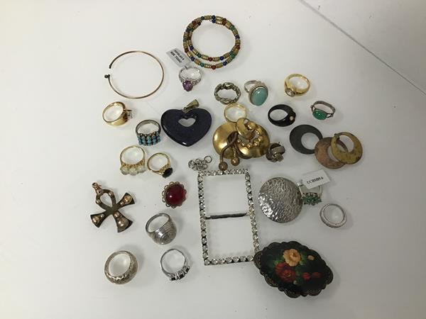 An assortment of costume and silver jewellery including a silver Egyptian style ankh, rings, buckle,