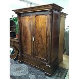 A handsome Victorian mahogany wardrobe, the moulded cornice above two panelled doors, flanked by