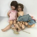 A pair of 1950s dolls, with articulated limbs and a small collection of doll clothing (largest doll: