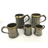 A group of pewter tankards, all with brass rims, including two Quarts, two pints and two half pints,