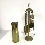 A brass companion set with brush, shovel, tongs and poker (h.55cm), and a 1954 shell casing