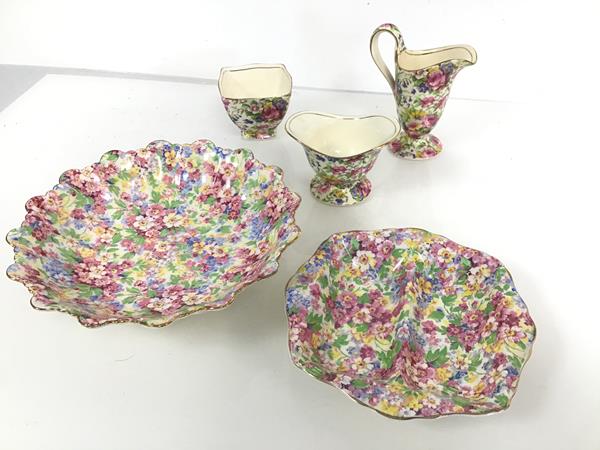 A collection of polychrome floral 1930s china, including milk jug, sugar bowl and footed bowl with