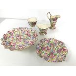 A collection of polychrome floral 1930s china, including milk jug, sugar bowl and footed bowl with