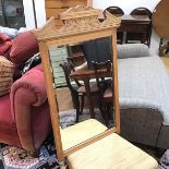 A wall mirror with moulded surmount over bevelled glass, formerly a dressing table mirror (83cm x