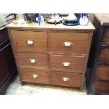 A mid 20thc teak bank of drawers, with two columns of short drawers, with panelled sides and back (