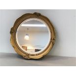 A gilt circular French style wall mirror with bevelled glass plate (outer frame: d.37cm)