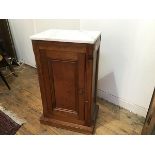 A 19thc pitch pine bedside with white veined marble top and inset panel door, raised on plinth