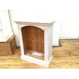 A white painted upright open bookcase with arched top fitted two shelves, on plinth base (98cm x