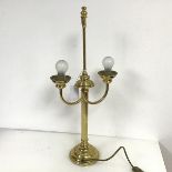 A brass two arm table lamp with reeded column on domed base, inscribed Quality Brassware, made in