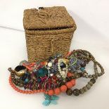 An assortment of costume jewellery including paste and wooden bead necklaces, bangles, bracelets,