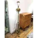 An Edwardian telescopic brass oil lamp converted to floor lamp, with fluted centre column, raised on