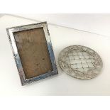 An Edwardian silver photograph frame (16cm x 11cm) and a glass coaster with mounted silver