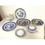 An assortment of 19thc blue and white transfer ware, including a Willow pattern bowl, ashet and