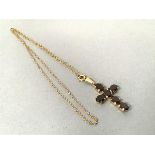 A 9ct gold garnet mounted crucifix, each oval garnet mounted in claw setting, on 9ct gold trace link