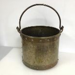A brass and copper bound and studded bucket, with swing handle (26cm x d.32cm)