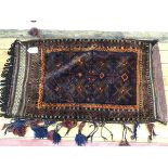 A Kurdish nomadic saddle bag with centre panel of stylised foliate design enclosed within a