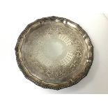 An Edwardian Sheffield silver footed salver with gadrooned scalloped edge and foliate and star