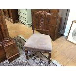 An Edwardian nursing chair, the crest with central rosette over pierced floral splat, with