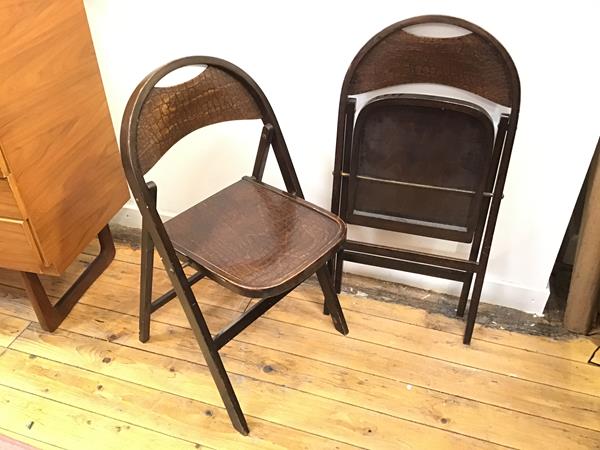 A pair of 1970s folding chairs, the domed top rail over an imitation lizardskin back splat with