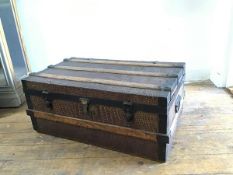 A late 19thc metal and oak bound rectangular travelling trunk with twin handles to side and faux