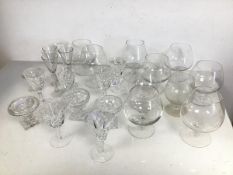 A collection of drinking glasses including brandy glasses, sherry glasses, liqueur glasses etc. (a