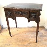 A Victorian oak lowboy, the rectangular top with relief carved edge above a centre lion mask
