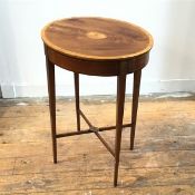 An Edwardian oval mahogany occasional table, with inlaid centre paterae, with satinwood
