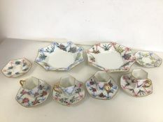 A set of four Limoges demi tasse and six saucers and two shallow bowls, all with ribbon and floral