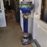 A majolica jardiniere on similar fluted Corinthian style columnar stand (combined height: 138cm)