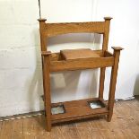 An oak Arts & Crafts hallstand, lacking superstructure, with hinged compartment above a base with