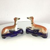 A pair of 19thc Staffordshire hound quill holders, decorated with polychrome enamels (10cm x 11cm