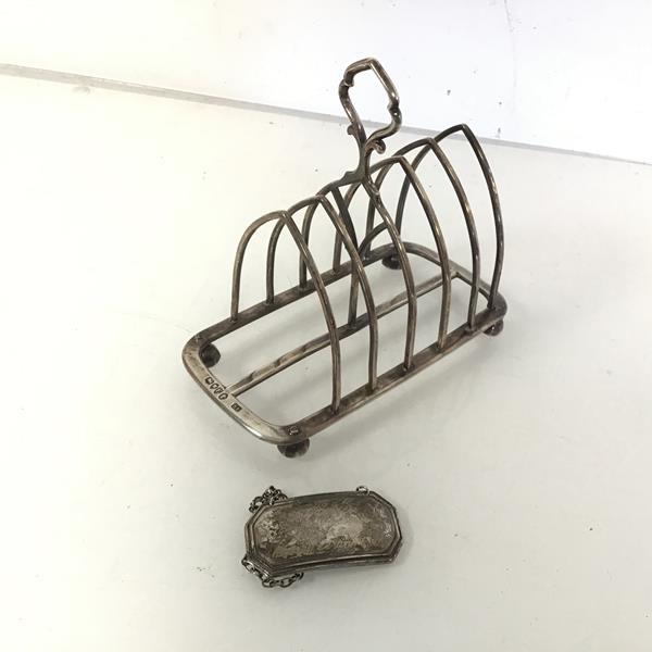 A Gothic style Victorian London silver toastrack (a/f) (12cm x 13cm x 7cm) and a silver decanter