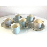 Five WH Goss turquoise lustre coffee cans and saucers, one with hairline crack to base and an