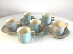 Five WH Goss turquoise lustre coffee cans and saucers, one with hairline crack to base and an