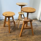 A pair of pine circular adjustable stools raised on tripod splay supports (44cm (fully extended: